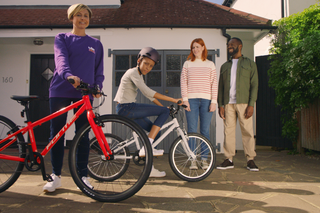 child with parents and bike
