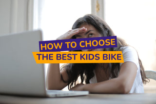 women sitting at desk with hand on her forehead looking stressed