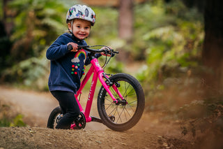 child on a pink bike