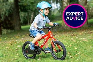 child on a bike with helmet