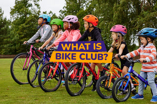 A group of children sitting on bikes in the outdoors